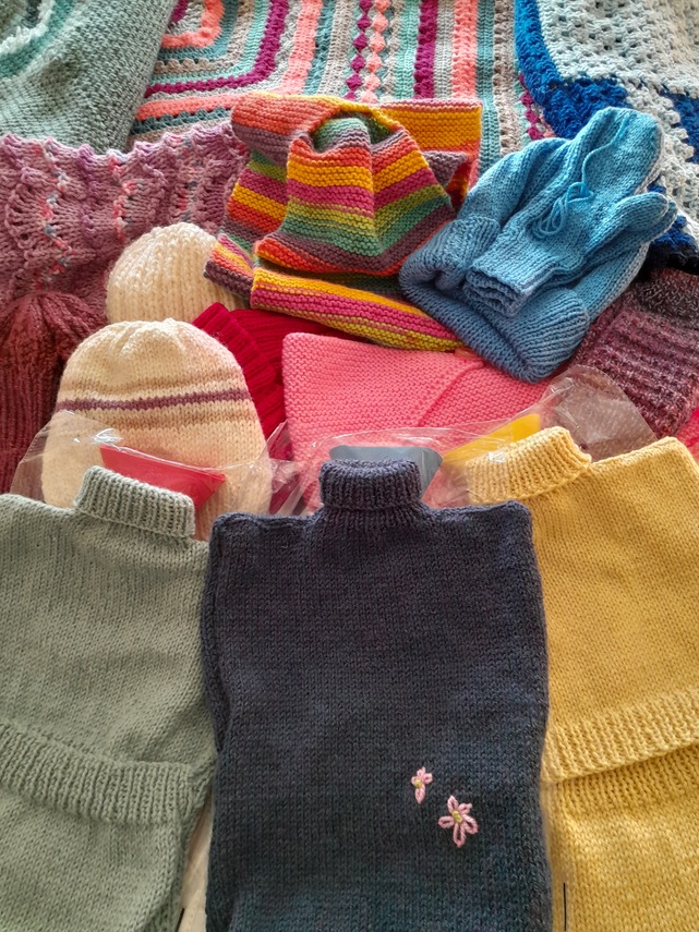 Photo of knitted hats, hot water bottle covers, mittens etc