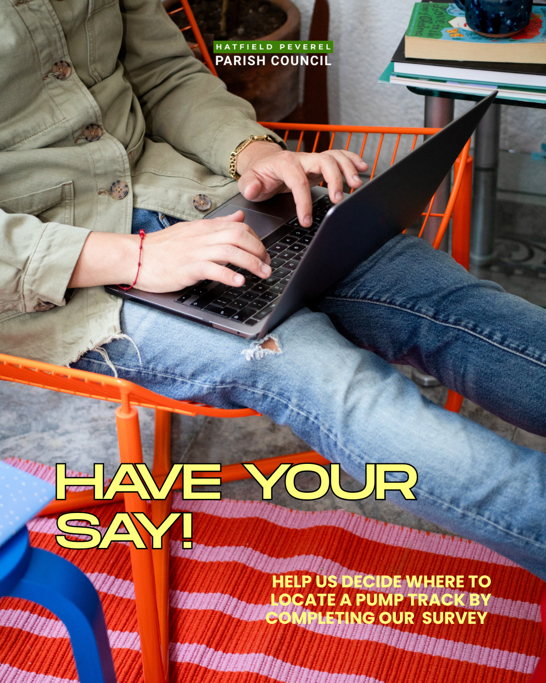 A young person sitting on a red chair while on a laptop. Wording reads Have Your Say, help us decide where to locate a pump track by completing our survey